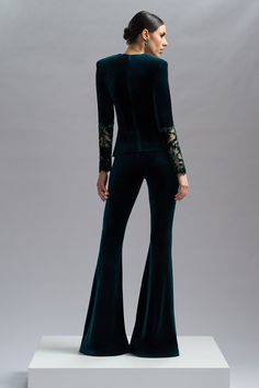 CRISTALLINI VELVET VOGUE pants are a combination of style and comfort, perfect for adding a touch of elegance and sophistication to any outfit.    Velvet flared pants    Hook and fastenings zip on the side    Dry clean    Shown color: Black, Green    Made In EU Elegant Flares For Night Out, Elegant Fall Flares Trousers, Elegant Flares For Fall, Elegant Wide-leg Party Flares, Elegant Wide-leg Flares For Party, Elegant Wide-leg Flares For Evening, Elegant Stretch Flares, Elegant Party Flares, Tailored Flare Pants For Party