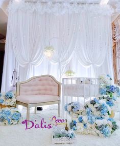 a baby's room decorated with blue and white flowers