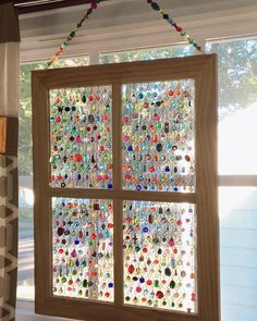 a window covered in lots of different colored buttons