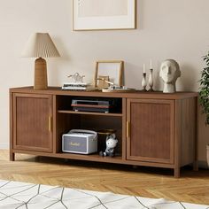 a living room with an entertainment center in the corner and a lamp on top of it