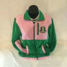 a green and pink jacket with pearls on the collar