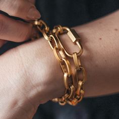 Make a bold statement with this street-chic gold paperclip bracelet. Defined by its strong, chunky chains, this gold-toned bracelet also features a carabiner link. Versatile and easy to style, this chain can be worn either as a necklace or as a double wrap bracelet, perfect when worn on its own or artfully stacked with your other favorite pieces. Length: 15” Can be worn as a necklace or as a double wrap bracelet The chain is 14K gold plated over brass with a burnished finish The clasp is an easy Paperclip Bracelet, Double Wrap Bracelet, Layered Bracelets, Street Chic, Paper Clip, Wrap Bracelet, Layering, Gold Plate, Plating