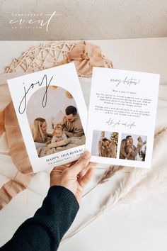 a person holding up two cards with the word joy on them and an image of their family