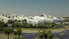 an aerial view of a large white building surrounded by palm trees