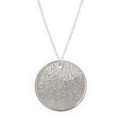 "Memorialize significant moments with our keepsake worthy Large Medallion Necklace - from children's names and birthdates to words that call to mind a special occasion. Each letter is individually stamped by hand, making the large medallion necklace one of a kind. This necklace features our signature teeny-tiny block font accented by our diamond dusted texture cascading down the face of the pendant. You can also select the diamond dusted pendant without a message. details + large medallion measu White Gold Necklace With Large Pendant For Anniversary, Round Charm Necklace With Large Pendant As Gift, Charm Necklaces With Large Round Pendant For Gifts, Nickel-free White Gold Necklace For Personalized Gift, Personalized White Gold Nickel-free Necklace, Sterling Silver Necklace With Large Round Disc Pendant, Silver Round Pendant Necklace For Celebration, White Gold Medallion Necklace For Personalized Gifts, Silver Initial Pendant Jewelry For Keepsake