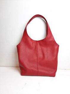 "Leather tote bag made of soft high-quality leather in red. Extra big dimensions for all your toting needs! A versatile bag for everyday work and study or going out on the town. Pleated top with magnetic fastening. - One outer pocket with zipper. - Cotton lining with zippered pockets,and pocket for mobile phone. - Two shoulder straps. - You can choose from 7 leather colors. - Cotton lining, you can choose from 7 different linings. Free delivery is economic delivery. We use Latvian post and deliv Red Shoulder Bag With Rolled Handles For Shopping, Red Double Handle Shoulder Bag With Rolled Handles, Red Soft Leather Bucket Bag For Everyday Use, Red Shoulder Bag With Rolled Handles, Everyday Red Soft Leather Hobo Bag, Red Leather Bag With Rolled Handles, Red Shoulder Bag With Rolled Handles For Daily Use, Everyday Red Soft Leather Shoulder Bag, Leather Hobo Bag With Rolled Handles