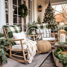 a porch decorated for christmas with rocking chairs, pillows and wreaths on the front porch