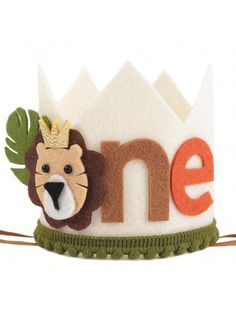 a small crown with a lion on it's head and the word me spelled out in large letters