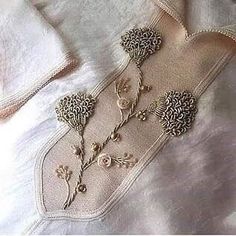 an embroidered piece of cloth with flowers on it