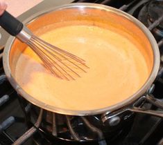 a person is whisking something in a pan on top of the stove with an electric burner