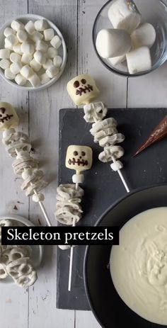 skewered pretzels with marshmallows in bowls and spoon on the side