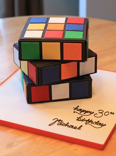 a birthday cake made to look like rubik's cubes are stacked on top of each other