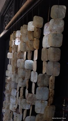 several pieces of white marble hanging from strings