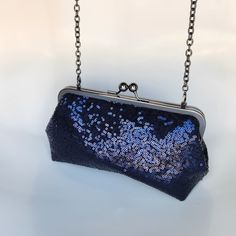 "Navy Blue sequins clutch with antique bronze metal purse frame. The inside is gold satin (not waterproof). Handy pocket inside holds business cards, ID and credit cards. The purse is large enough to hold sunglasses, cell phones, pens, compacts...everything you need for a night out! Choose your metal purse frame finish: antique bronze (pictured), silver, rose gold or gunmetal  Other sequins colors available: black, rose gold, champagne, gold, silver and red (purchase this listing and let me know what color you want in the \"notes to seller\" section at checkout) Dimensions: 8\" wide metal frame on top, 8.75\" wide at the bottom, 3\" deep x 5\" tall Inside pocket measures 2\" x 4\". Add a personalized message of any length to the inside pocket for only $6. Please provide exact message text Navy And Gold Wedding, Navy Clutch, Bridesmaid Clutch, Wedding Navy, Sequin Purse, Metal Purse, Bridesmaid Clutches, Sequin Clutch, Purse Frame