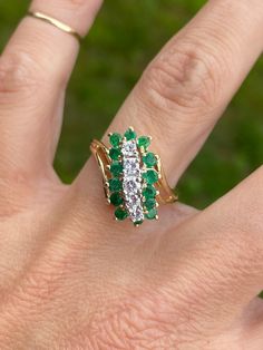 Gorgeous sparkle on this one!   There are approx .30ctw of genuine diamonds H/I1, and approximately .28ctw of genuine round emeralds.   The ring measures 15mm at the widest point and tapers to 2mm in the back. It is stamped for 14K yellow gold. It weighs 5.4g.  Size 6.75 and sizable.  We are happy to offer sizing for an additional charge. Let me know if you need a quote on sizing. Green Cluster Diamond Ring Fine Jewelry, Emerald Cluster Ring With Diamonds, Green Diamond Ring With Single Cut Diamonds For Anniversary, Green Emerald Cluster Ring With Diamonds, Green Multi-stone Diamond Ring, Emerald Diamond Ring With Single Cut Diamonds For Anniversary, Green Cluster Diamond Ring For Anniversary, Cluster Emerald Ring With Vvs Clarity, Emerald Ring With Pave Setting For May Birthstone Anniversary