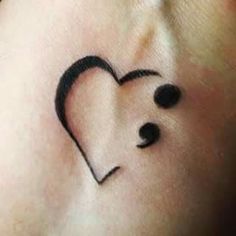 a small heart tattoo on the wrist