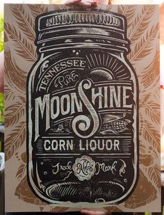 a person holding up a poster with the words moon shine on it