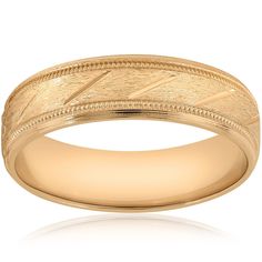 a yellow gold wedding ring with an engraved design