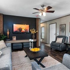 a living room filled with furniture and a ceiling fan