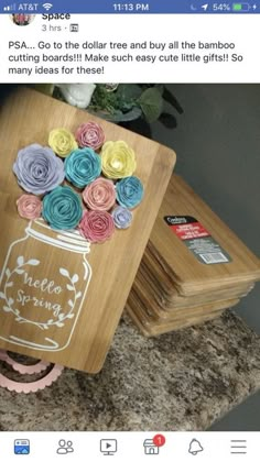 some paper flowers in a mason jar on top of wooden boards with the words hello to the dollar tree and buy all the bamboo