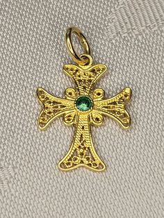 The filigree work on this vintage piece is just beautiful. This is a vintage 18K yellow gold Christian Cross likely made in Europe. The cross is marked 750 which is 18K. The cross is 7/8 of an inch high and 5/8 of an inch wide and weighs 1.2 grams of 18K gold. The centre of the cross piece is enameled in green enamel. Excellent condition. Free delivery.  -PLEASE read the description carefully and examine all of the photos for the piece of interest to you prior to purchase. If you have questions, I will be pleased to answer you.  -I do NOT accept refunds or exchanges. - I will consider layaway plans, as long as a 25% down initial payment is made. This first downpayment is non-refundable. Full payment on layaway items is expected within two months. Please contact me in advance to discuss. Gold Cross Jewelry With Intricate Design, Gold Cross Pendant Jewelry With Intricate Design, Traditional Yellow Gold Cross Pendant Jewelry, Gold Intricate Cross Jewelry, Gold Cross Pendant With Intricate Design, Vintage Yellow Gold Cross Necklace, Gold Filigree Cross Jewelry, Antique Cross Pendant Jewelry With Intricate Design, Traditional Filigree Cross Jewelry