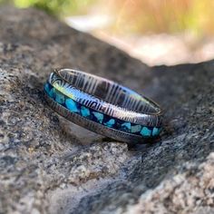 This is a USA-made comfort fit 6mm wide Damascus Steel with a rounded top profile, acid etch, and a 2-millimeter turquoise & lapis lazuli inlay. It is very comfortable to wear with a rounded comfort fit design. This ring is hand-finished & designed by jewelry artisans who have a passion for unique jewelry & uncompromising quality. 6mm Damascus steel Acid-etched 2mm center turquoise & lapis lazuli Inside comfort fit design SKU: DD-WHT-6HR12G-Turq-Lps Made In The USA Box Color May Damascus Ring, Damascus Steel Ring, Box Color, Damascus Steel, Steel Ring, Damascus, Lps, Custom Rings, Lapis Lazuli