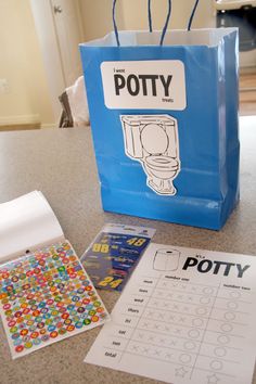 a blue bag sitting on top of a counter next to a sheet of paper and stickers