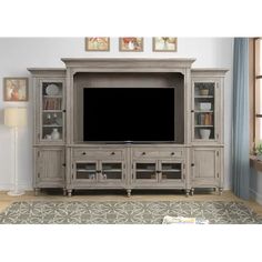 an entertainment center with a large tv on it's side and shelves in the middle