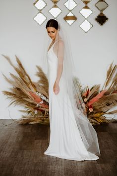 a woman in a white wedding dress and veil