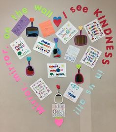 a heart shaped bulletin board with magnets and pictures on the wall above it that says, i see kinds of things