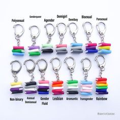 a bunch of different colored plastic items on a keychain that are labeled with the names of each item