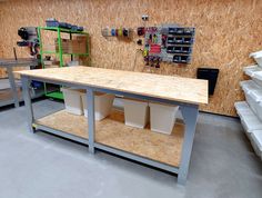 a workbench with several bins and tools on it in a storage area