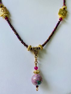 This precious necklace sparkles in Gold and Purple. The centerpiece is antique enamel. Purple Enamel Necklace For Gift, Purple Enamel Necklace For Gifts, Gold Czech Glass Pendant Necklace, Elegant One-of-a-kind Gold Beaded Necklaces, Handmade Pink Enamel Necklaces, Spiritual Enamel Round Pendant Necklace, Gold Czech Glass Round Necklace, Gold Spiritual Decorative Necklace, Decorative Gold Spiritual Necklace