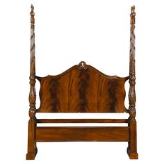 an antique wooden bed frame with carved wood headboard and foot board, on white background