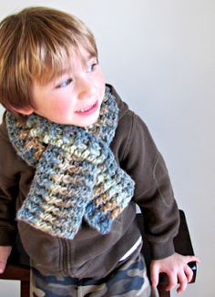 a young boy wearing a knitted scarf