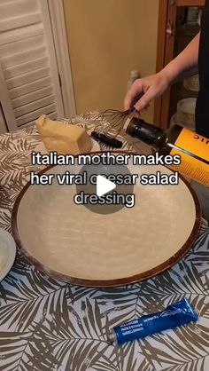 a woman is pouring wine into a bowl