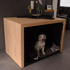 a dog is sitting in its cage on the floor next to a table with flowers