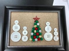 a christmas tree made out of buttons in a frame