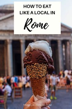 an ice cream cone with chocolate and sprinkles in front of a building