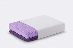 a purple and white mattress sitting on top of each other