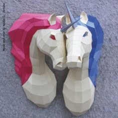 two paper horses are on the ground with scissors