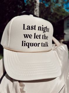 "Our Trucker Hat is a letter print stylish design take on a vintage design. It is 7-position adjustable snap closure and iconic flat bill add a subtle charm that takes you back to the good all days. The summer hat is printed with \"Last Night We Let The Liquor Talk Trucker Hat\" on the front side. Our Snapback Trucker Hat is made of high-quality material, with a structured and high-profile silhouette. The snapback hat is durable and easy to carry. The hat cap is an excellent fit and can be put in hell and still hold shape. The hat is the ideal choice in acknowledgment of its sharp styling, spirited color, and lively white underbill. Benefit: Adjustable snapback closure for a perfect fit Durable construction for long-lasting use Stylish and trendy design for a fashionable look A versatile a Vintage Letter Print Baseball Cap For Summer, Summer Graphic Print Baseball Cap, Adjustable Trucker Hat With Letter Print And Flat Brim, Vintage White Snapback Hat With Letter Print, White 5-panel Snapback Hat With Letter Print, White Trucker Hat With Letter Print, White Trucker Hat With Letter Print And Flat Brim, Summer Graphic Print Trucker Hat, Summer Cap With Graphic Print