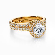 a yellow gold engagement ring set with two rows of diamonds