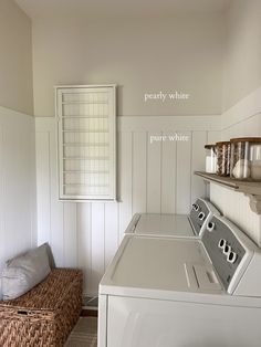 a washer and dryer in a small room with white paneling on the walls