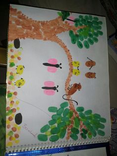 a child's drawing of a giraffe and tree with leaves on it