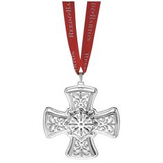 a medal with a cross on it and a red ribbon around the neck that says,