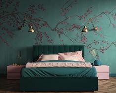 a bedroom with teal walls and pink flowers painted on the wall above the bed