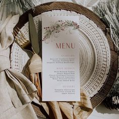 a menu sitting on top of a plate next to a knife and fork with napkins around it