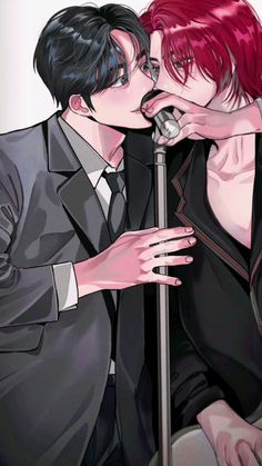 two people kissing each other while wearing black suits and red hair, one holding a microphone