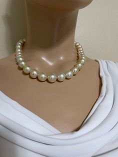 Light Gold South Sea Pearl Necklace. This hand knotted necklace features 35 Light Gold South Sea Pearls AA+ High Luster Round 10-14mm. These Pearls are Genuine and natural in color. They do have some light surface blemishes which is common in real pearls. This strand is hand knotted with white silk thread and finished with a 14K yellow gold button bead clasp 8.5mm. The necklace measures 18 inches in length. The necklace pictured is the one you will receive. Please visit our shop for more pearls Elegant Cream Necklaces With Large Beads, Elegant Cream Jewelry With Large Beads, Elegant Large Bead Pearl White Necklace, Elegant Pearl White Necklace With Large Beads, Elegant Large Beaded Pearl White Necklace, South Sea Pearl Necklace, Keshi Pearl Necklace, Hand Knotted Necklace, Knotted Necklace